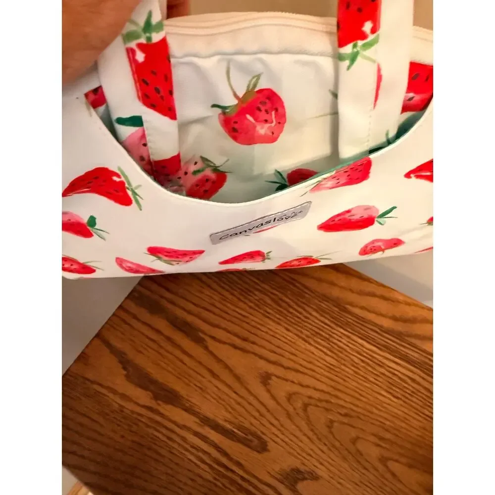 Canvaslove laptop sleeve features strawberry print, detachable shoulder strap